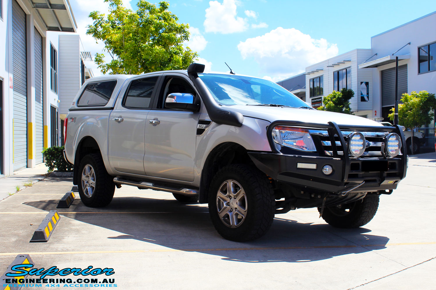 Left front side view of a Silver Ford PX Ranger after fitment of a Bilstein 2" Inch Lift Kit + Airbag Man Leaf Air Kit