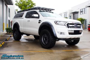 Right front side view of a White Ford PXII Ranger after fitment of the Superior Diff Drop Kit