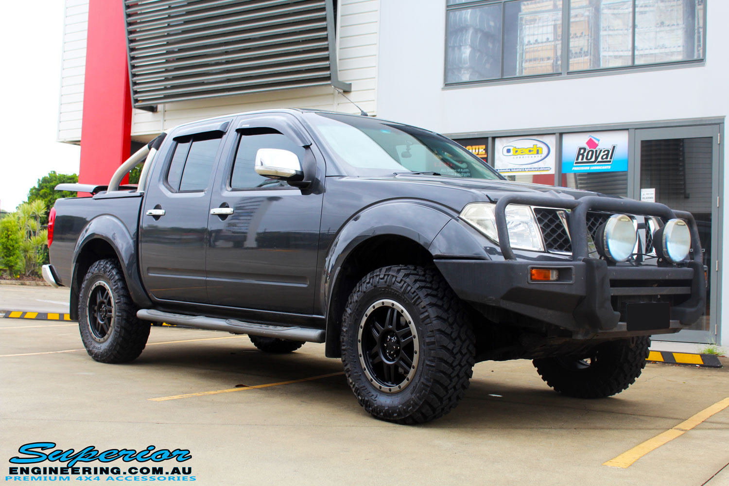 Right front side view of a Nissan D40 Navara Dual Cab after fitment of a Superior Nitro Gas 2" Inch Lift Kit, Airflow Snorkel & Nitto Trail Grappler Tyres + Tuff T16 Alloys