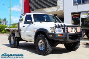 Right front side view of a White GU Patrol Ute before fitment of a Superior Nitro Gas Hyperflex 4" Inch Lift Kit, Tie Rod Heim Joint + Coil Tower Brace Kit