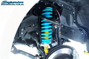 Front left inside guard view of the fitted Bilstein 2" Strut with Coil Spring