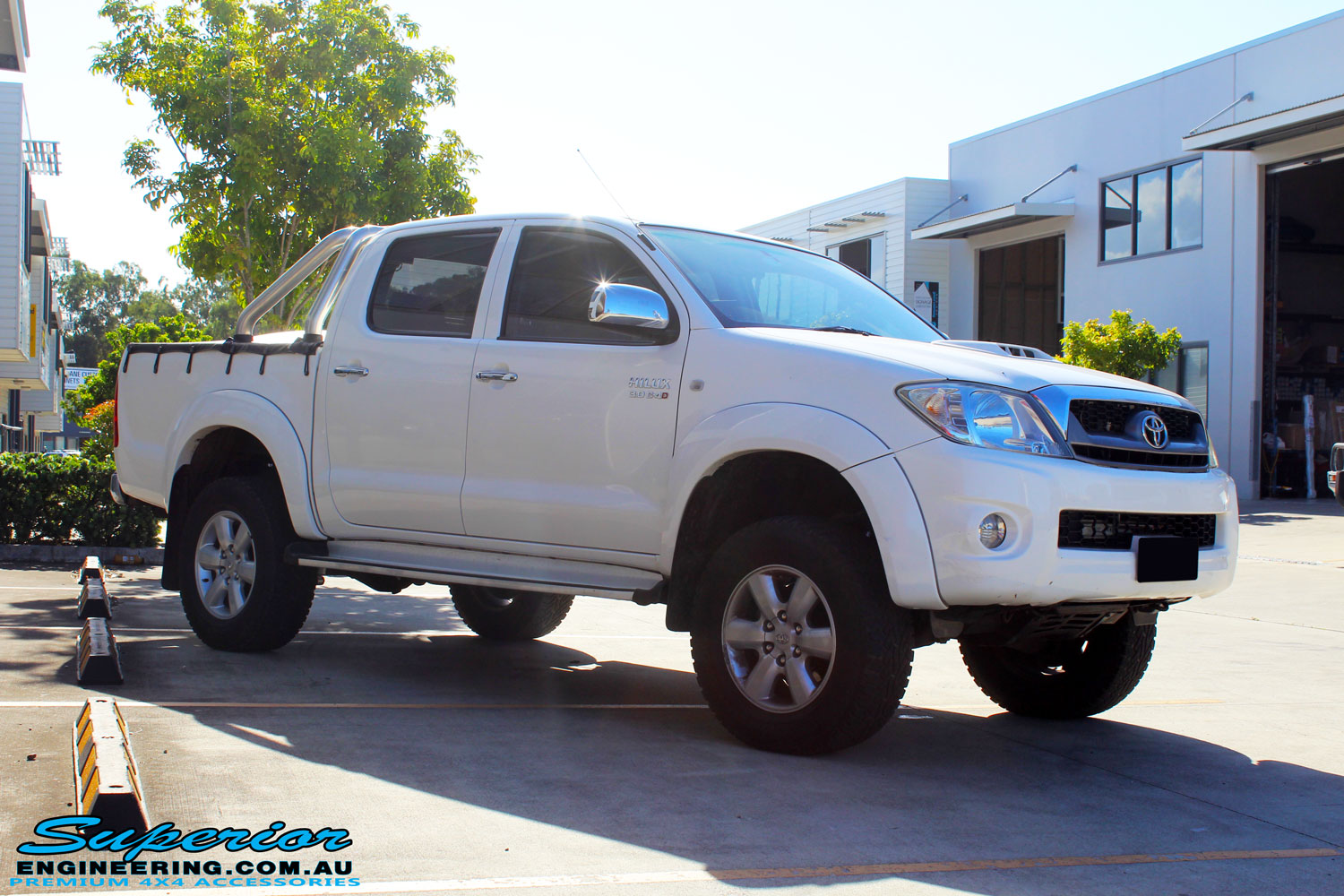 Right front side view of a Toyota Vigo Hilux Dual Cab in White after fitment of a Superior Nitro Gas 2" Inch Lift Kit