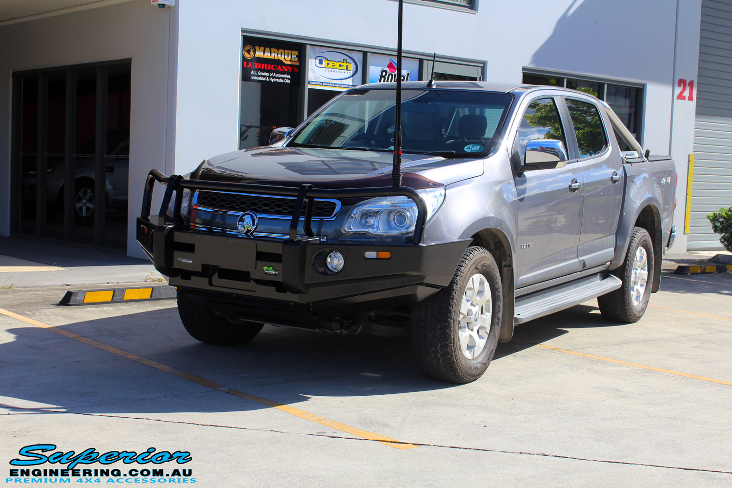 Left front side view of this Holden RG Colorado in Grey after fitment of a Ironman 4x4 Deluxe Black Bull Bar & GME UHF