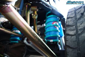 Left mid rear up close view of the fitted Superior Lower Control Arm, Coil Spring with Airbag Man Coil Air Kit and Sway Bar Kit