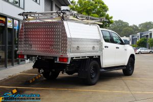 Rear right view of a White Toyota Revo Hilux Dual Cab before fitment of a Bilstein 2" Inch Lift Kit