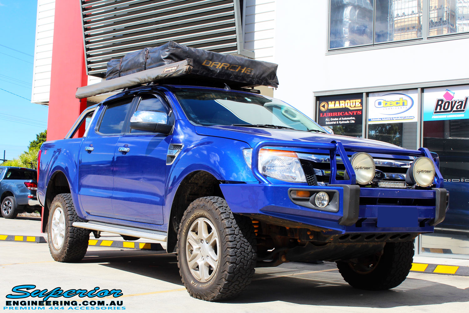 Right front side view of a Ford PXII Ranger in Blue after fitment of a Superior Nitro Gas 2" Inch Lift Kit