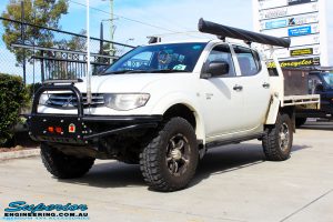 Left front side view of a White Mitsubishi MN Triton after fitment of a 20mm Lift Kit