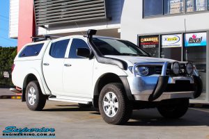 Right front side view of a Mitsubishi MN Triton in White On The Hoist @ Superior Engineering Deception Bay Showroom