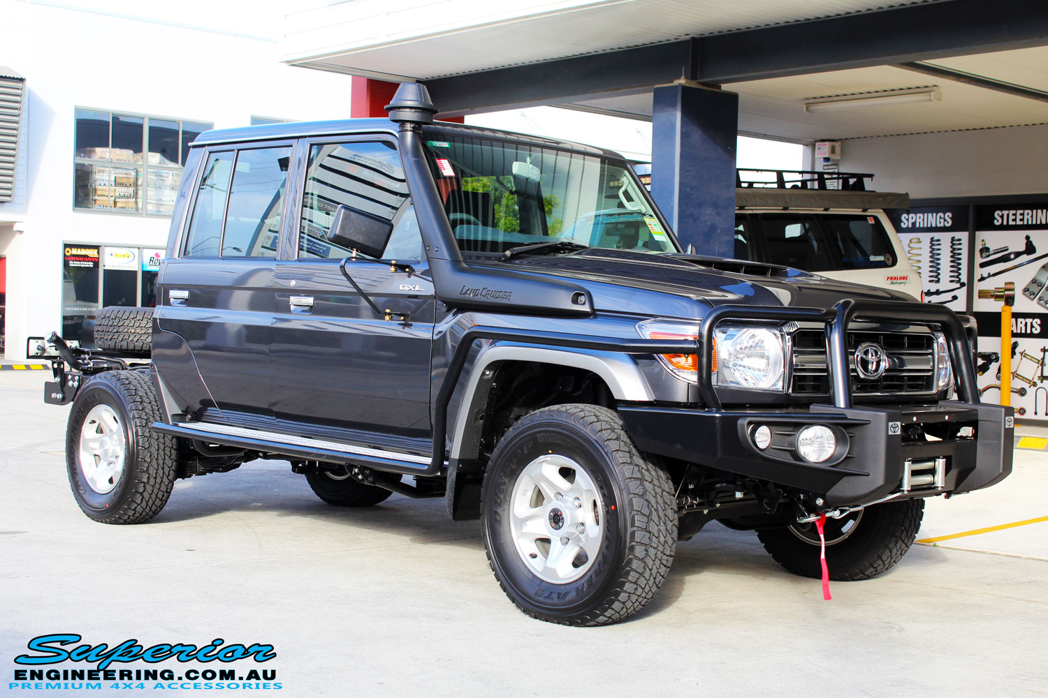 Right front side view of a Grey Toyota 79 Series Landcruiser after fitment of a MDT Tru Tracker Complete Rear Track Correction System