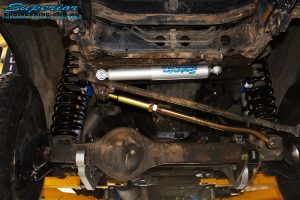 Front underbody view of the fitted Superior Steering Damper, Adjustable Panhard Rod, Superflex Radius Arms, 4" Inch Nitro Gas Shocks & Coil Springs