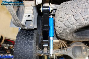 Rear left underbody shot of the fitted Superior Nitro Gas 3" Shocks + EFS Leaf Springs with U-Bolt Kit