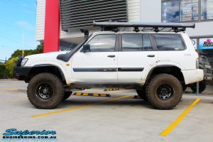 Left side view of a White Nissan GU Patrol Wagon after being fitted with Superior Hybrid 5 Link Radius Arms, 55mm Shock Tower Lift Kit & Bump Stop Extensions