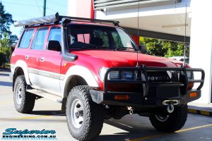 Right front side view of a Red Toyota 80 Series Landcruiser before fitment of a Fox 2.0 Performance Series IFP 2" Inch Lift Kit