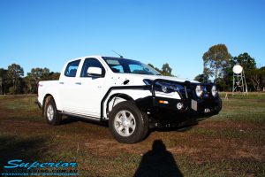 Right front side view of a White Isuzu D-Max Dual Cab being fitted with a Superior Remote Reservoir 2" Inch Lift Kit, Airbag Man Leaf Air Kit, Ironman 4x4 Bullbar + Side Steps, VRS Winch, Safari Snorkel + King Wheels & Nitto Tyres