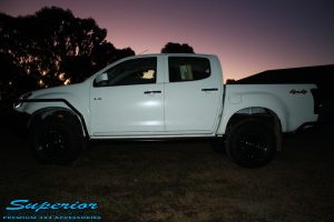 Right side view of a White Isuzu D-Max Dual Cab being fitted with a Superior Remote Reservoir 2" Inch Lift Kit, Airbag Man Leaf Air Kit, Ironman 4x4 Bullbar + Side Steps, VRS Winch, Safari Snorkel + King Wheels & Nitto Tyres