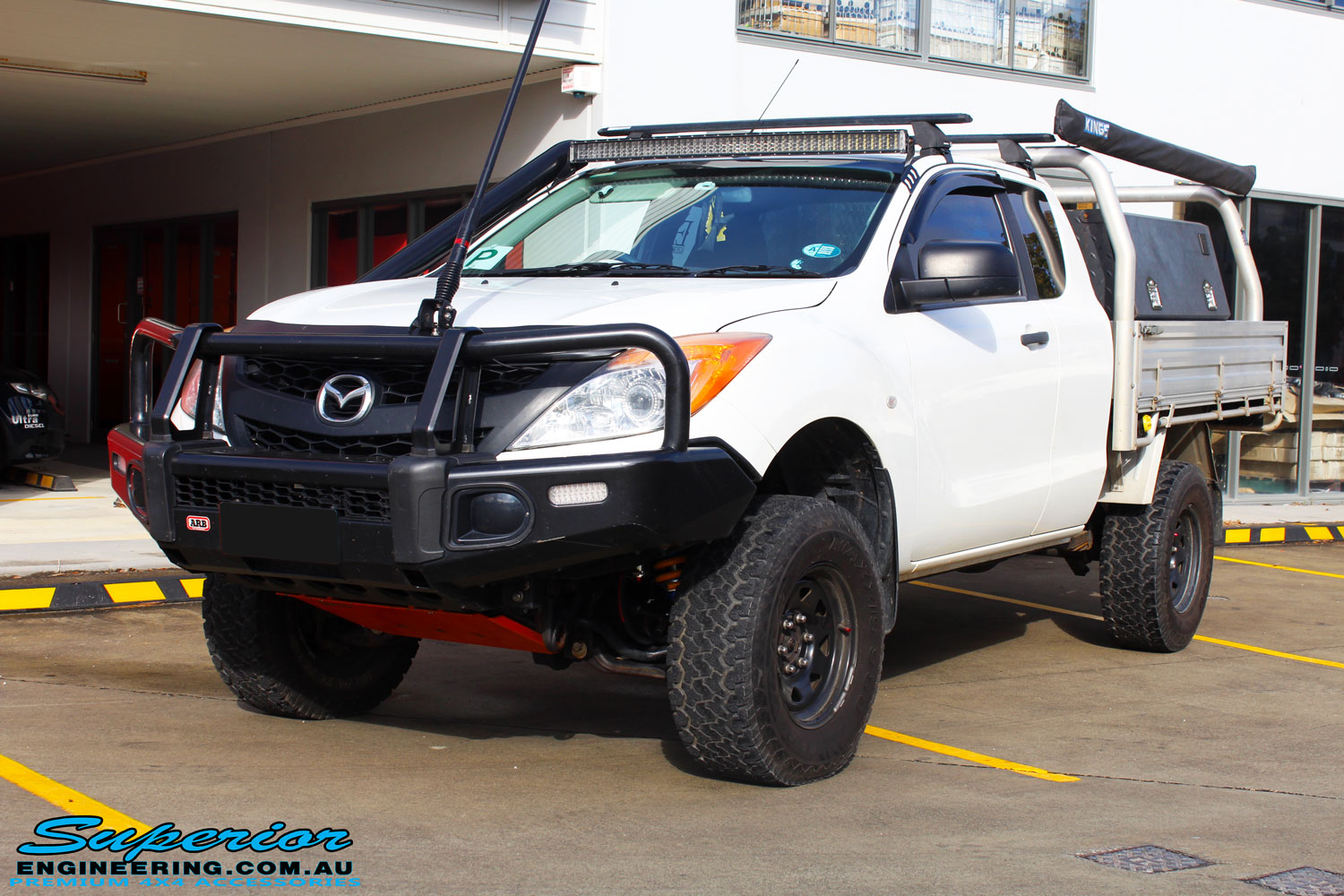 Left front side view of a White Mazda BT50 Freestyle Cab after fitment of a range of quality parts and accessories from Superior Engineering