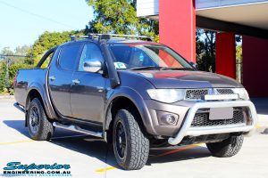 Right front side view of a Mitsubishi MN Triton in Bronze before fitment of a Superior Nitro Gas 2" Inch Lift Kit + 2" Inch Body Lift