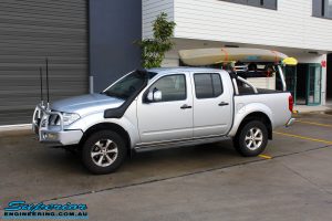 Left front side view of a Nissan D40 Navara in Silver On The Hoist @ Superior being fitted with a Chassis Brace/Repair Plate
