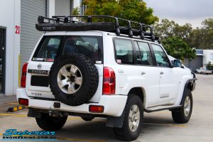 Rear right view of a White Nissan GU Patrol Wagon after fitment of a Superior Nitro Gas 2" Inch Lift Kit