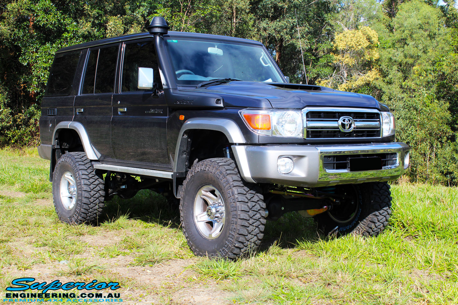 Front right side view of a Grey Toyota 76 Series Landcruiser after fitment of a Superior 5" Inch Remote Reservoir Superflex Lift Kit