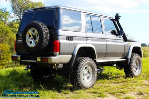 Rear right shot of a Grey Toyota 76 Series Landcruiser after fitment of a Superior 5" Inch Remote Reservoir Superflex Lift Kit