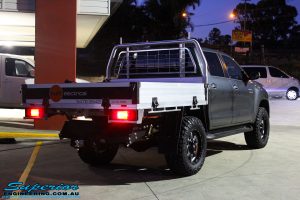 Rear right view of a Toyota Revo Hilux Dual Cab in Grey after fitment of a Fox 2.0 Performance Series IFP 2" Inch Lift Kit + Upper Control Arms