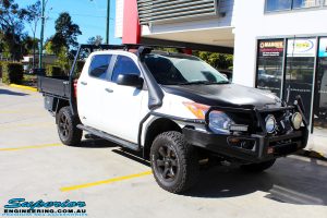 Right front side view of a Mazda BT-50 in White On The Hoist @ Superior Engineering Deception Bay Showroom