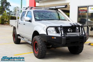 Right front side view of a Nissan D40 Navara in Silver On The Hoist @ Superior being fitted with a Chassis Brace/Repair Plate