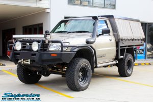Left front side view of a Gold Nissan GU Patrol Ute being fitted with Superior Superflex Sway Bar Kit & a Superior Shock Tower Kit
