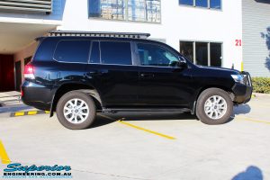 Right side view of a Toyota 200 Series Landcruiser Wagon in Black before fitment of a Ironman 4x4 50mm Lift Kit with Superior Diff Drop Kit