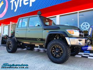 Right front side view of a Green Toyota 79 Series Landcruiser Dual Cab after fitment of a Superior 4" Inch Remote Reservoir Superflex Lift Kit