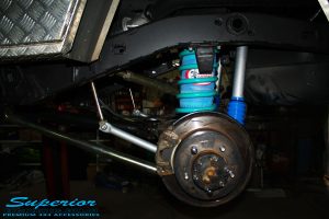 Rear left shot of the fitted Airbag Man Coil Air Helper Kit, Remote Reservoir Shock & Swaybar Kit