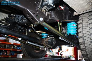 Mid rear left view of the fitted Superior Lower Control Arm, Sway Bar Kit & Airbag Man Coil Air Helper Kit with Coil Spring