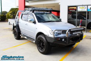 Right front side view of a Mitsubishi MN Triton in Silver before fitment of a Superior Nitro Gas 2" Inch Lift Kit & Superior Chassis Repair Plate
