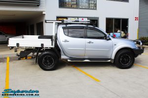 Right side view of a Mitsubishi MN Triton in Silver before fitment of a Superior Nitro Gas 2" Inch Lift Kit & Superior Chassis Repair Plate