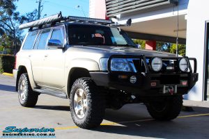 Right front side view of a Nissan GU Patrol Wagon in Gold On The Hoist @ Superior Engineering Deception Bay Showroom