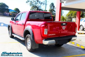 Rear left side view of a Red Nissan NP300 Navara Dual Cab before fitment of a Superior Remote Reservoir 3" Inch Lift Kit