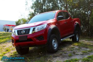 Left front side view of a Red Nissan NP300 Navara Dual Cab after fitment of a Superior Remote Reservoir 3" Inch Lift Kit