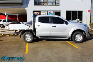 Right side view of a Silver Nissan NP300 Navara Dual Cab before fitment of a Superior Remote Reservoir 2 Inch Lift Kit & Airbag Man Coil Air Kit 2" Inch Lift