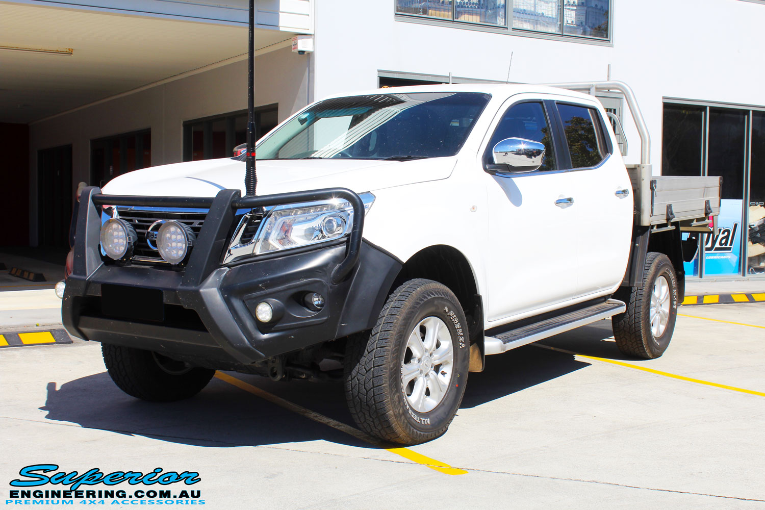 Left front side view of a White Nissan NP300 Navara Dual Cab after fitment of a 2" Inch Lift Kit
