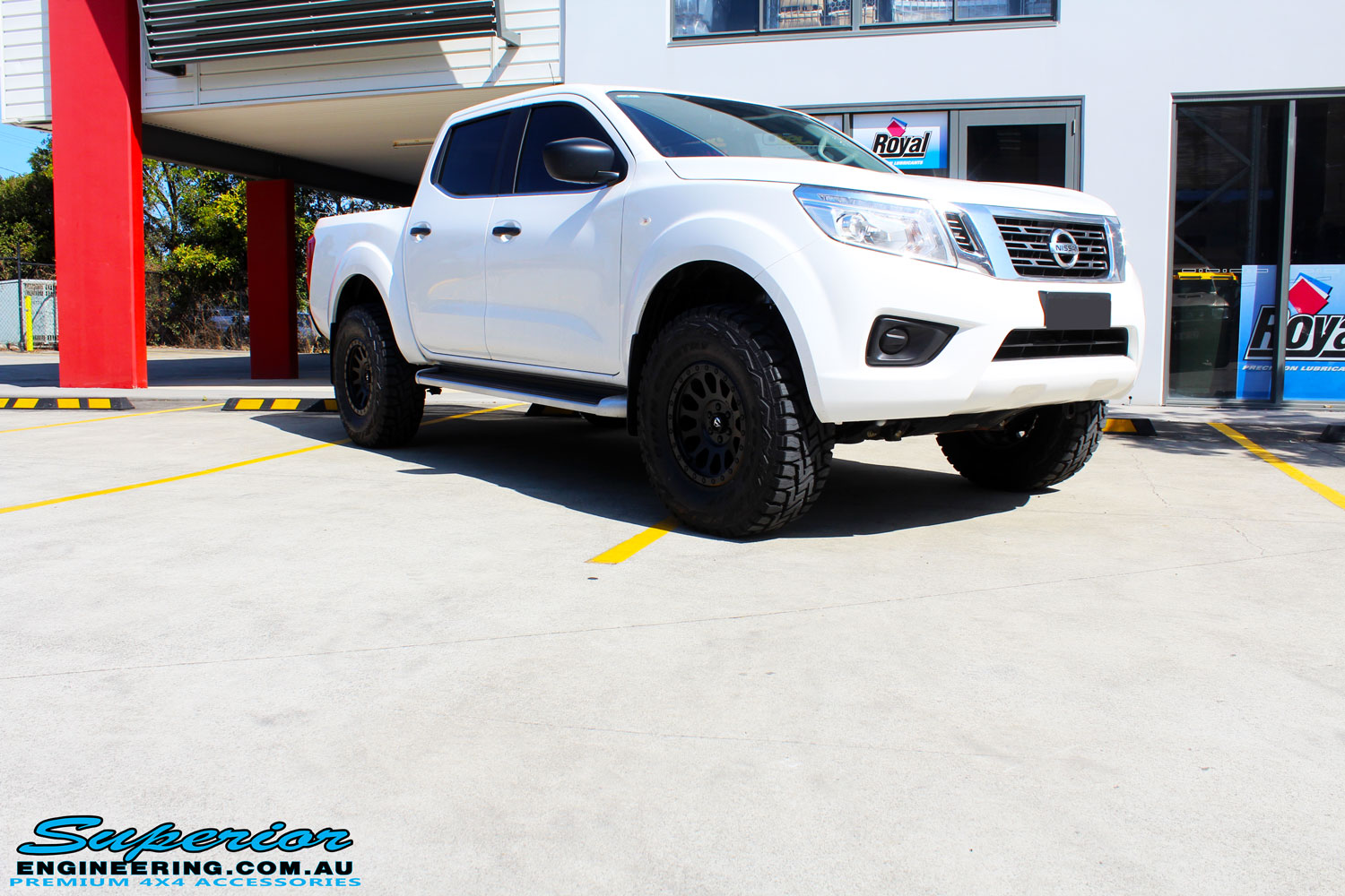 Right front side view of a White Nissan NP300 Navara Dual Cab after fitment of a range of Superior and various other brands suspension components