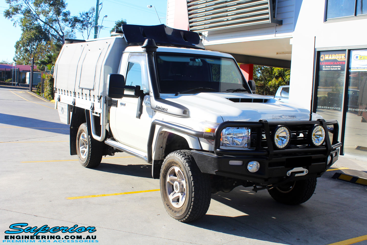 Right front side view of a White Toyota 79 Series Landcruiser before fitment of a MDT Tru Tracker Complete Rear Track Correction System