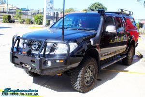 Right front side view of a Nissan D40 Navara in Black On The Hoist @ Superior being fitted with a Chassis Brace/Repair Plate