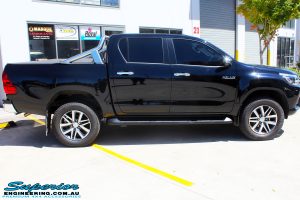 Right side view of a Toyota Revo Hilux Dual Cab in Black before fitment of a Superior Remote Reservoir 3" Inch Lift Kit