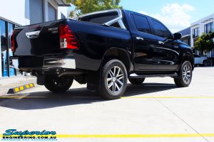 Rear right view of a Toyota Revo Hilux Dual Cab in Black before fitment of a Superior Remote Reservoir 3" Inch Lift Kit
