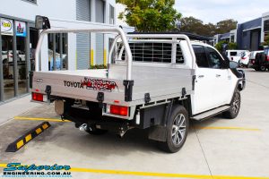 Rear right view of a White Toyota Revo Hilux before fitting a Superior Remote Reservoir 2" Inch Lift Kit