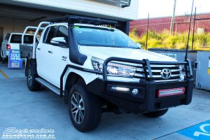 Left front side view of a White Toyota Revo Hilux after fitting a Superior Remote Reservoir 2" Inch Lift Kit