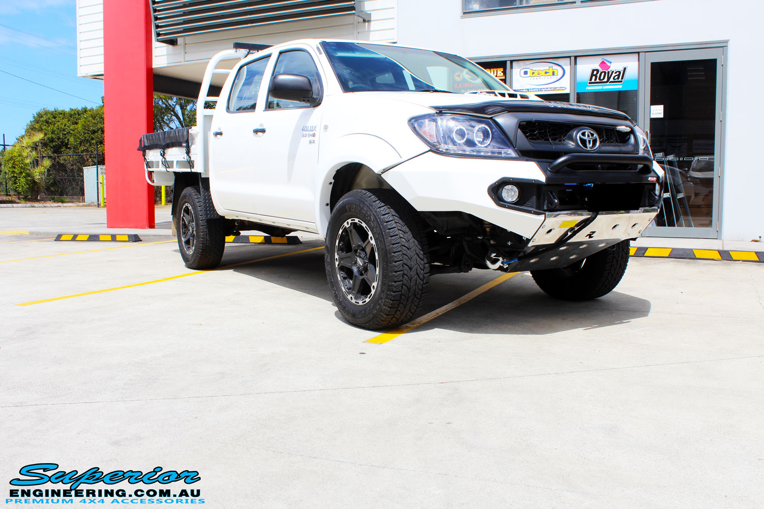 Right front side view of a Toyota Vigo Hilux Dual Cab in White after fitment of a Superior Nitro Gas 2" Inch Lift Kit, Rhino 4x4 Evolution 3D Winch Bar, VRS Winch, Legendex 409 Stainless Steel 3" Exhaust, Legendex Thrust Monkey Throttle Control, Legendex Rock Sliders, Legendex Optimizer Remap Service, Stainless Snorkel & Nitto Trail Grappler Tyres