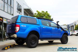 Rear right view of a Blue Ford PXII Ranger after fitment of a Superior Nitro Gas 2" Inch Lift Kit with King Springs & EFS Springs