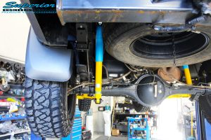 Rear left underbody view of the fitted Bilstein Shocks + EFS Leaf Springs